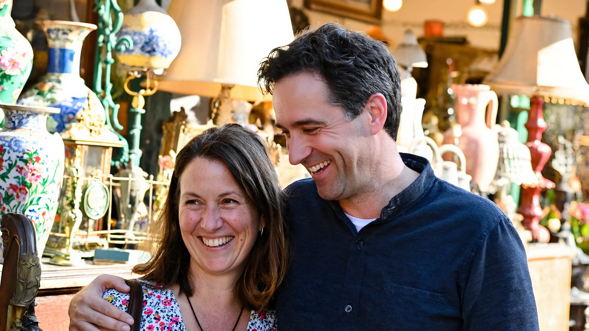 A smiling couple browsing colorful antiques in a sunlit antique shop near Ponchatoula, Louisiana